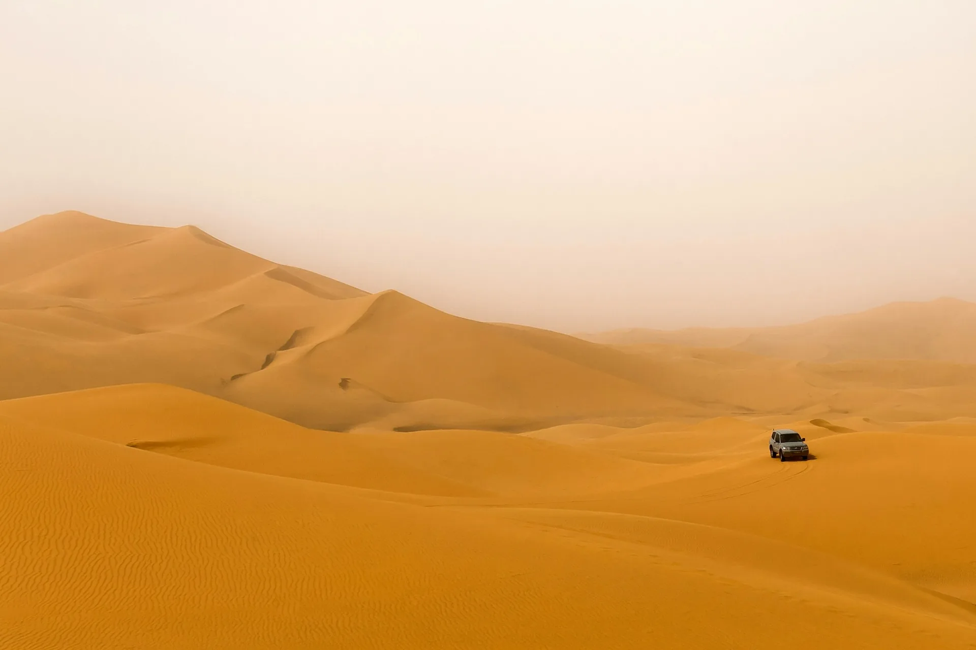 4×4 crossing large Sahara sand dunes in Morocco