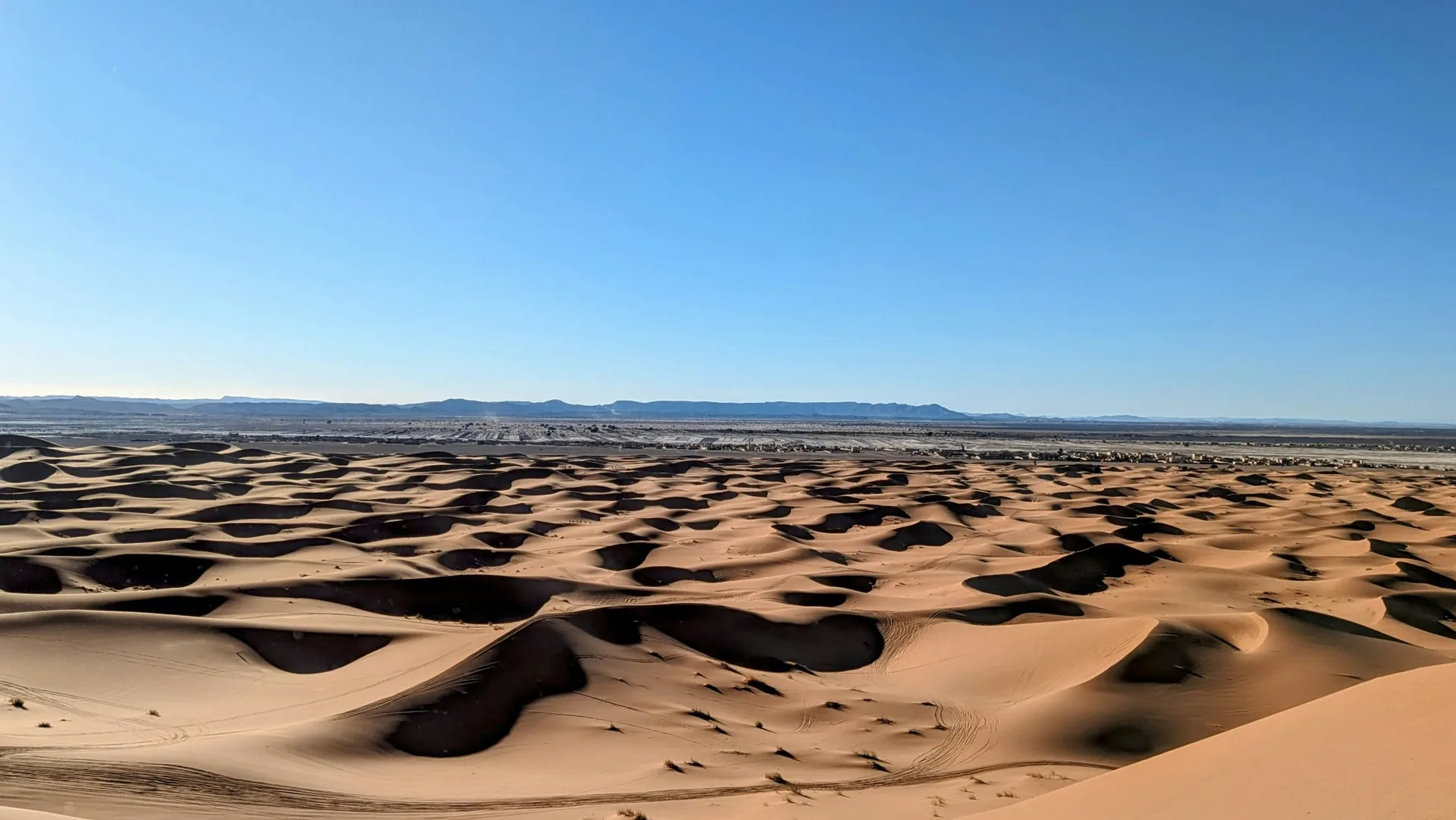 Toyota 4x4 crossing the Sahara dunes toward Erg Chegaga and Lake Iriki