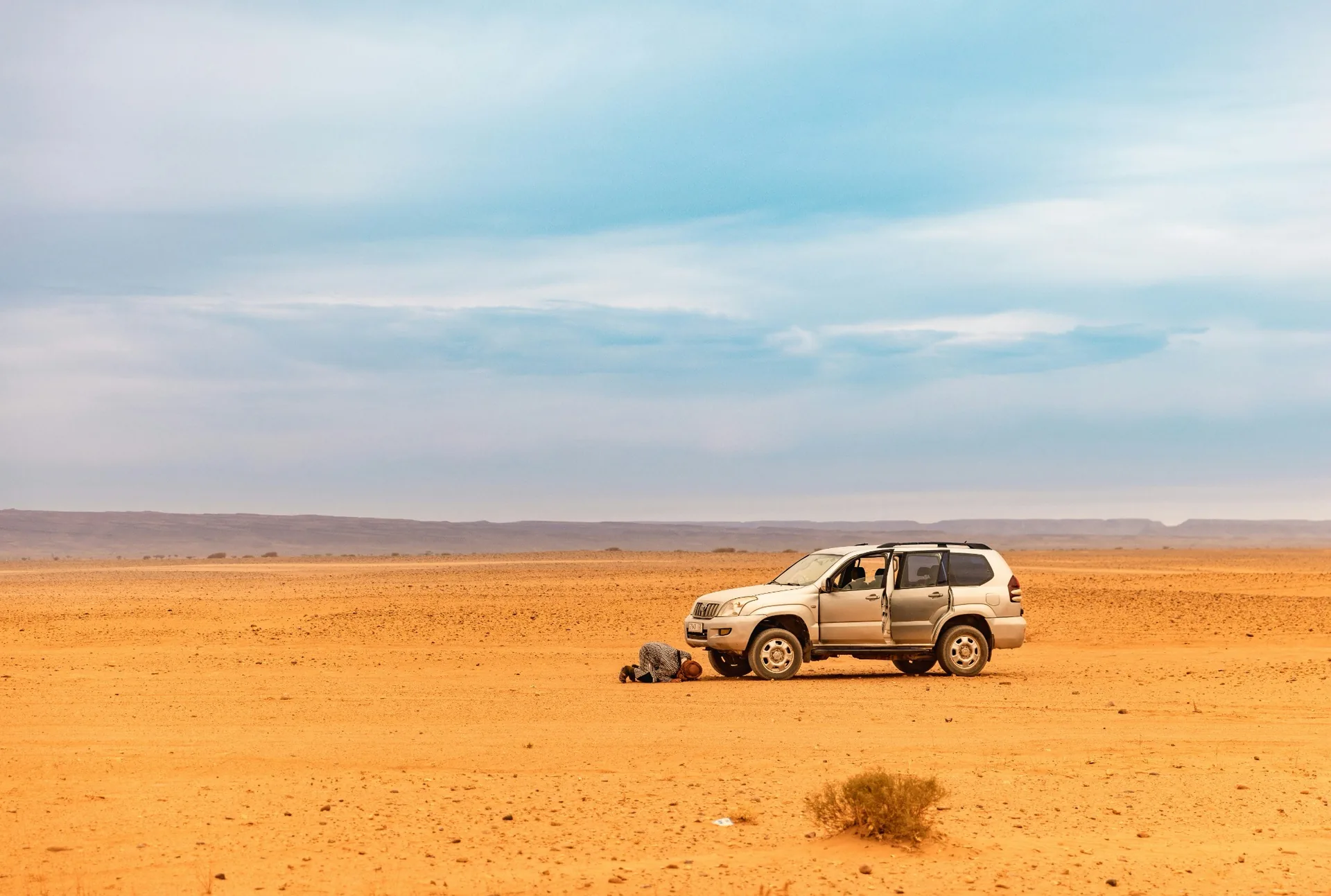 Toyota 4x4 crossing the Sahara dunes toward Erg Chegaga and Lake Iriki